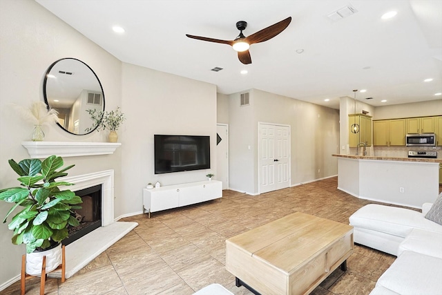 1689 Big Bend Dr, Lewisville, TX 75077 - living room with a fireplace with raised hearth, ceiling fan, baseboards, and recessed lighting
