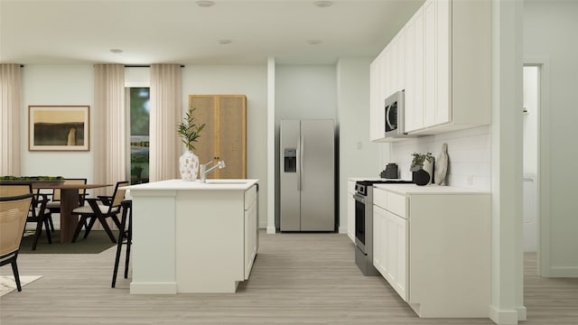 1816 Adams Dr, Little Elm, TX 75068 - kitchen with appliances with stainless steel finishes, a center island with sink, light wood-style floors, light countertops, and white cabinets