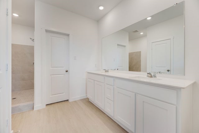 1301 Francesca Dr, Little Elm, TX 75068 - full bathroom featuring a walk in shower, double vanity, wood finished floors, and recessed lighting