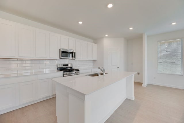 1301 Francesca Dr, Little Elm, TX 75068 - kitchen featuring stainless steel appliances, a sink, backsplash, light wood-type flooring, and recessed lighting