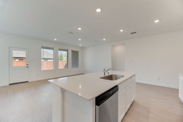 1301 Francesca Dr, Little Elm, TX 75068 - kitchen with a sink, stainless steel dishwasher, light wood finished floors, light countertops, and white cabinets