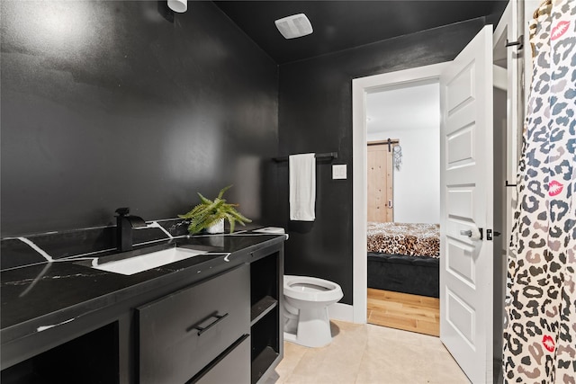 3412 Regal, Mesquite, TX 75149 - bathroom featuring toilet, vanity, tile patterned floors, and ensuite bath