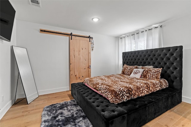 3412 Regal, Mesquite, TX 75149 - bedroom with a barn door, wood finished floors, baseboards, and recessed lighting