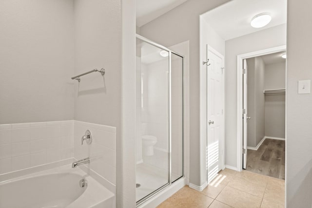 2004 Uvalde Dr, Forney, TX 75126 - full bathroom with a garden tub, a shower stall, tile patterned flooring, and a spacious closet