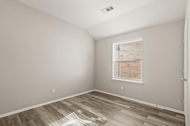 2004 Uvalde Dr, Forney, TX 75126 - unfurnished room featuring wood finished floors, lofted ceiling, and baseboards
