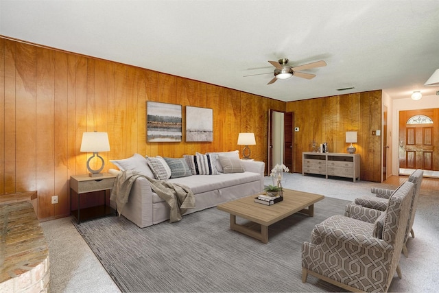 6417 Winifred Dr, Fort Worth, TX 76133 - living room featuring ceiling fan, carpet flooring, and wooden walls