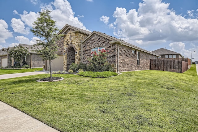 1217 Burlingame Dr, Cleburne, TX 76033 - view of front of house with concrete driveway, brick siding, and a garage