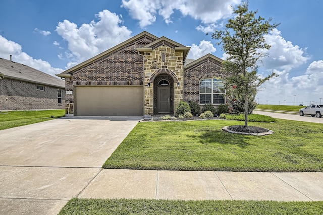 1217 Burlingame Dr, Cleburne, TX 76033 - french country home with driveway, an attached garage, a front yard, stone siding, and brick siding