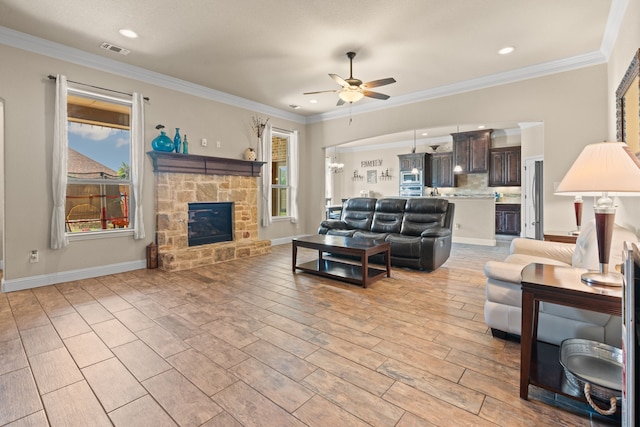 906 Joshua Ct, Granbury, TX 76048 - living room with a ceiling fan, plenty of natural light, recessed lighting, a stone fireplace, and ornamental molding