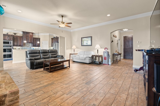 906 Joshua Ct, Granbury, TX 76048 - living area with arched walkways, a ceiling fan, light wood-style flooring, crown molding, and recessed lighting