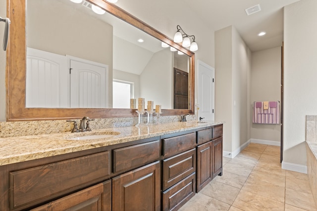 906 Joshua Ct, Granbury, TX 76048 - full bath with double vanity, baseboards, recessed lighting, and vaulted ceiling