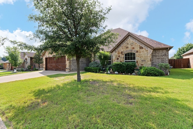906 Joshua Ct, Granbury, TX 76048 - view of front of home with driveway, stone siding, brick siding, and a garage