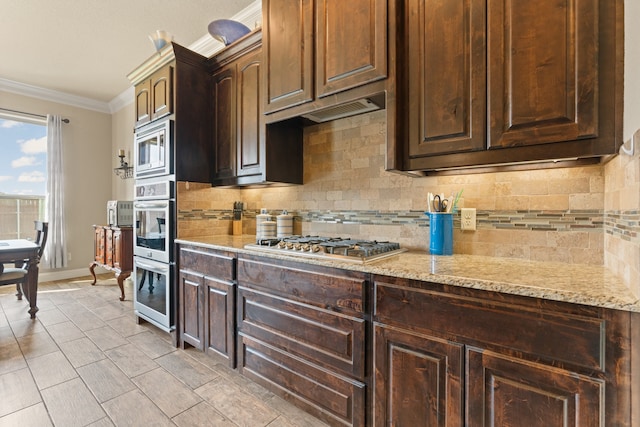 906 Joshua Ct, Granbury, TX 76048 - kitchen with ornamental molding, stainless steel appliances, tasteful backsplash, baseboards, and light stone counters