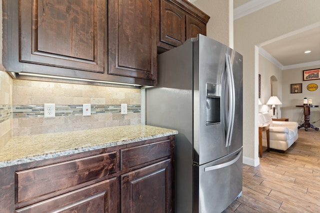 906 Joshua Ct, Granbury, TX 76048 - kitchen featuring stainless steel fridge, crown molding, dark brown cabinets, backsplash, and light wood finished floors