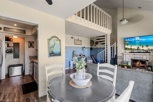 1006 Signal Ridge Pl, Rockwall, TX 75032 - dining space featuring dark wood finished floors, a stone fireplace, stairs, baseboards, and a ceiling fan
