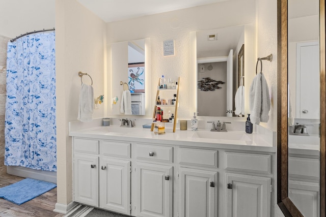 1006 Signal Ridge Pl, Rockwall, TX 75032 - full bath featuring double vanity and wood finished floors