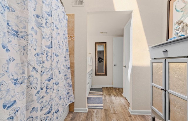1006 Signal Ridge Pl, Rockwall, TX 75032 - full bath with wood finished floors, baseboards, curtained shower, and vanity