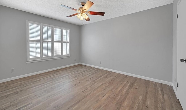 3732 N 24th St, Waco, TX 76708 - empty room featuring wood finished floors, a ceiling fan, a textured ceiling, and baseboards