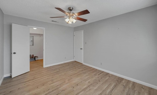 3732 N 24th St, Waco, TX 76708 - unfurnished bedroom with light wood-style floors, baseboards, a textured ceiling, and ceiling fan
