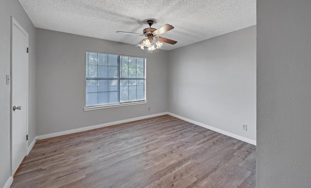 3732 N 24th St, Waco, TX 76708 - empty room with ceiling fan, wood finished floors, a textured ceiling, and baseboards