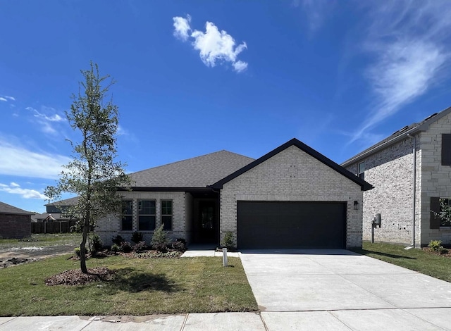 805 Roanoke, Princeton, TX 75407 - view of front facade with an attached garage, a front lawn, driveway, and brick siding