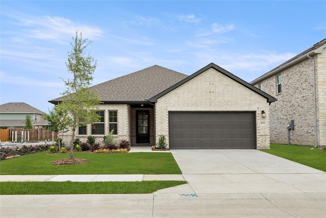 805 Roanoke, Princeton, TX 75407 - french provincial home with a garage, concrete driveway, brick siding, and a shingled roof