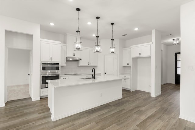 805 Roanoke, Princeton, TX 75407 - kitchen with double oven, black electric stovetop, recessed lighting, white cabinets, and decorative backsplash