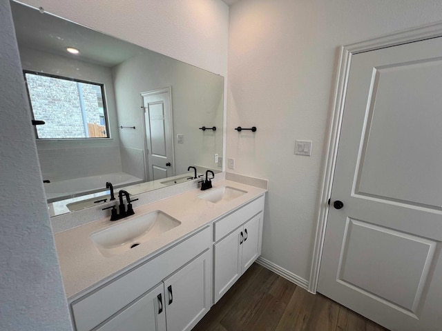 805 Roanoke, Princeton, TX 75407 - full bath featuring double vanity, wood finished floors, a bath, and baseboards
