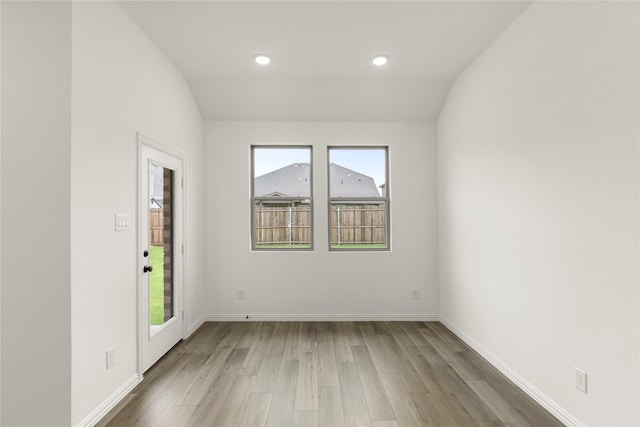 805 Roanoke, Princeton, TX 75407 - empty room with wood finished floors, lofted ceiling, and recessed lighting