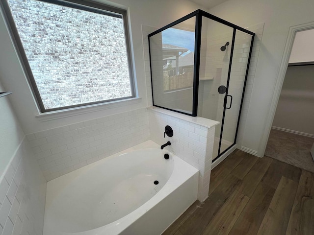 805 Roanoke, Princeton, TX 75407 - bathroom with a garden tub, wood finished floors, a stall shower, and baseboards