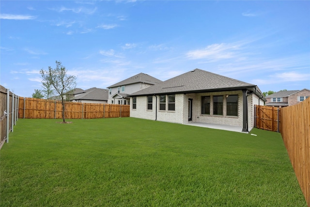 805 Roanoke, Princeton, TX 75407 - back of property with a fenced backyard, a shingled roof, a patio, and brick siding