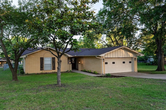 1019 Patricia Dr, Sherman, TX 75090 - ranch-style house featuring an attached garage, driveway, brick siding, and a front lawn