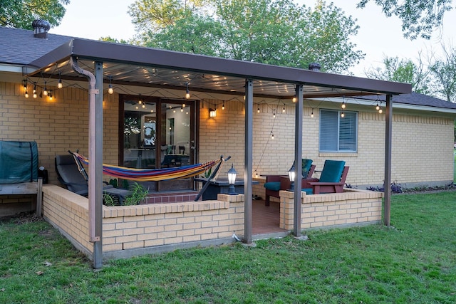 1019 Patricia Dr, Sherman, TX 75090 - rear view of house with brick siding, a lawn, a patio area, and a shingled roof