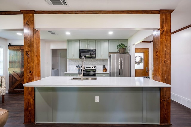 1019 Patricia Dr, Sherman, TX 75090 - kitchen featuring appliances with stainless steel finishes, dark wood-style floors, tasteful backsplash, light countertops, and recessed lighting