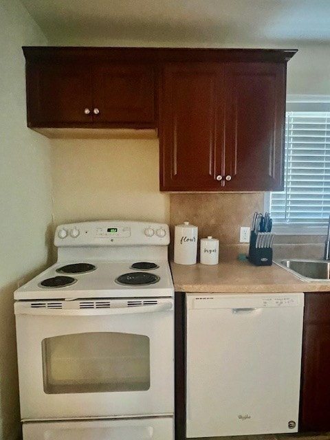 218 Wight St, Roxton, TX 75477 - kitchen with white appliances, a sink, light countertops, and dark brown cabinetry