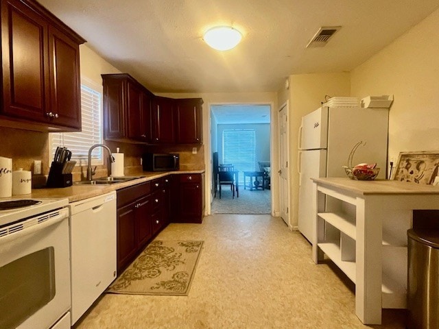 218 Wight St, Roxton, TX 75477 - kitchen featuring white appliances, a sink, light countertops, and light carpet