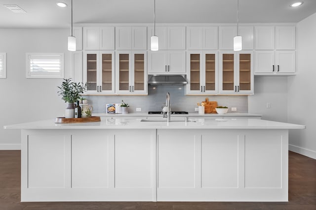 124 Craigmore Dr, Argyle, TX 76226 - kitchen with under cabinet range hood, white cabinets, light countertops, baseboards, and recessed lighting
