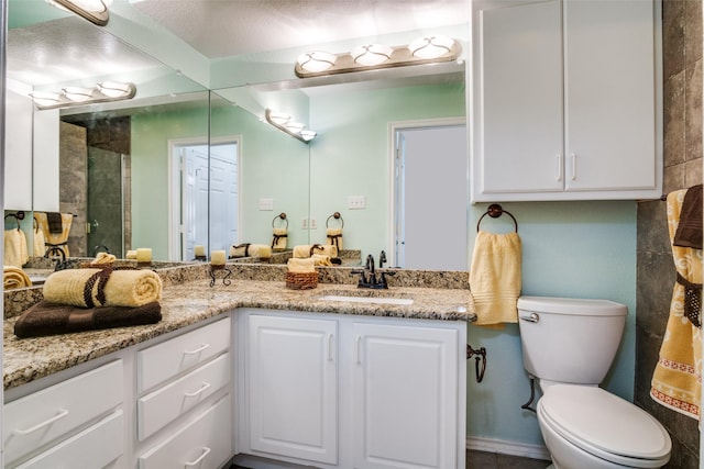 1112 Forest Creek St, Benbrook, TX 76126 - full bathroom with double vanity, a tile shower, and toilet