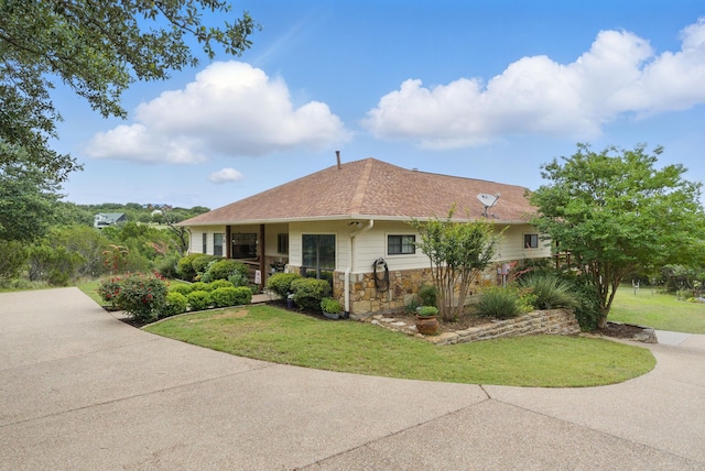 5925 Compass Way, Bluff Dale, TX 76433 - view of side of home with stone siding, a lawn, and roof with shingles