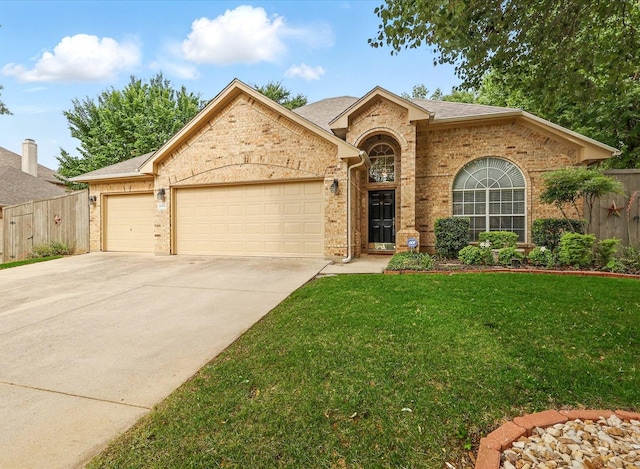 3812 Ridgemont Ln, Denton, TX 76210 - view of front of home featuring an attached garage, concrete driveway, and brick siding