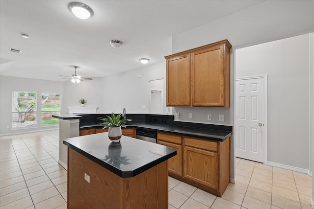 3812 Ridgemont Ln, Denton, TX 76210 - kitchen featuring a ceiling fan, dark countertops, dishwasher, light tile patterned floors, and brown cabinets