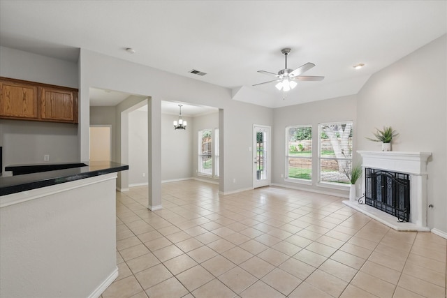 3812 Ridgemont Ln, Denton, TX 76210 - unfurnished living room featuring healthy amount of natural light, light tile patterned floors, a fireplace with raised hearth, and ceiling fan