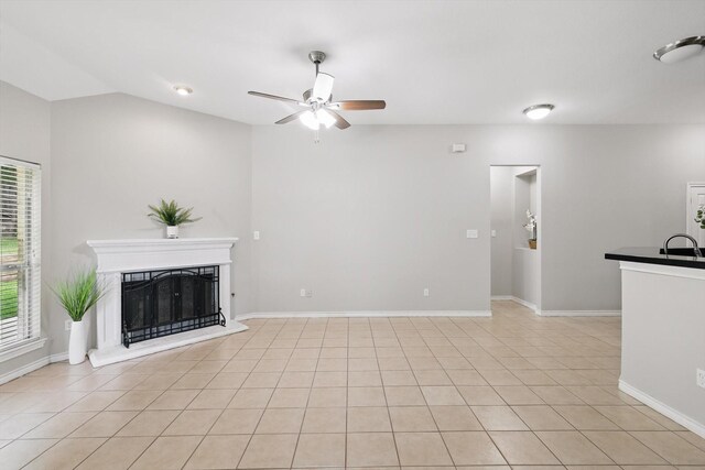 3812 Ridgemont Ln, Denton, TX 76210 - unfurnished living room featuring ceiling fan, a fireplace with raised hearth, a sink, baseboards, and vaulted ceiling