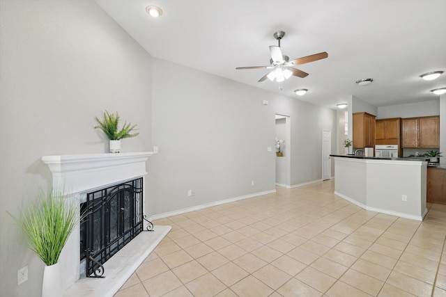 3812 Ridgemont Ln, Denton, TX 76210 - unfurnished living room with a ceiling fan, a fireplace with raised hearth, light tile patterned flooring, and baseboards