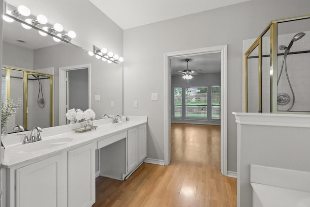 3812 Ridgemont Ln, Denton, TX 76210 - full bathroom featuring a stall shower, wood finished floors, double vanity, ceiling fan, and baseboards