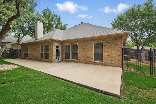 3812 Ridgemont Ln, Denton, TX 76210 - back of house with a chimney, brick siding, a shingled roof, and a patio area