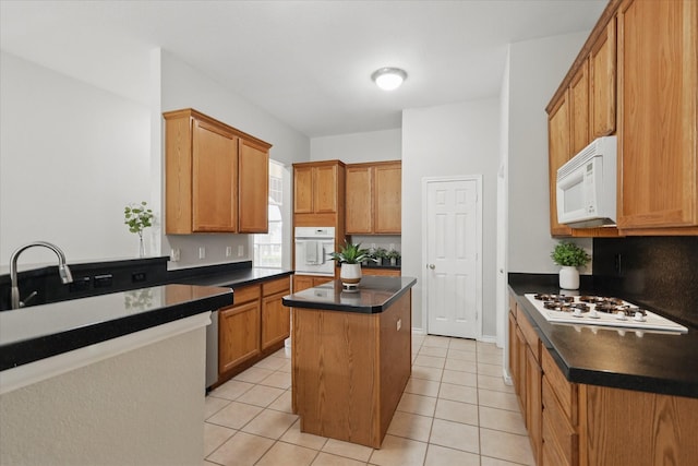 3812 Ridgemont Ln, Denton, TX 76210 - kitchen with white appliances, dark countertops, a center island, a sink, and light tile patterned floors