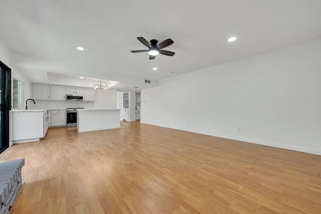 3008 Lindbergh Dr, Dallas, TX 75228 - unfurnished living room featuring a chandelier, a ceiling fan, light wood-style flooring, and recessed lighting