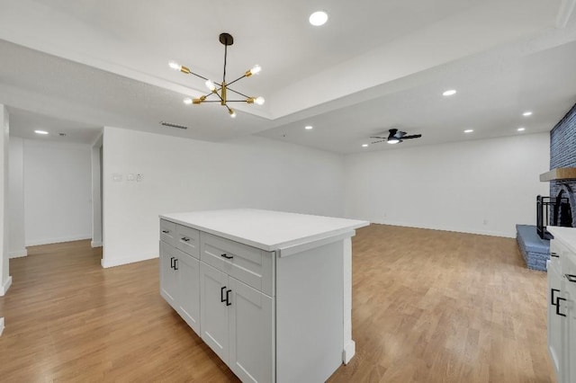 3008 Lindbergh Dr, Dallas, TX 75228 - kitchen featuring light wood-style floors, a chandelier, light countertops, a kitchen island, and recessed lighting