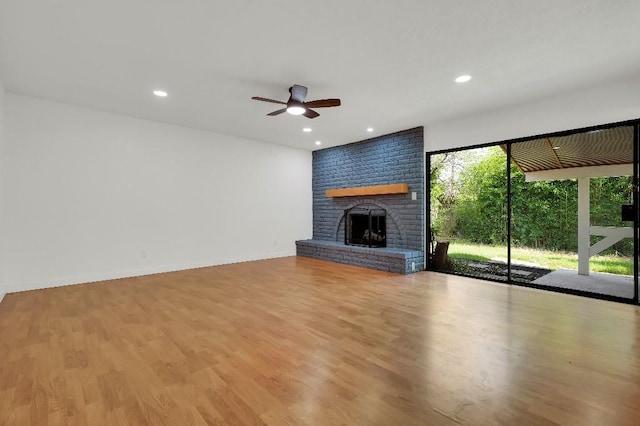 3008 Lindbergh Dr, Dallas, TX 75228 - unfurnished living room with ceiling fan, a fireplace, light wood-style floors, and recessed lighting
